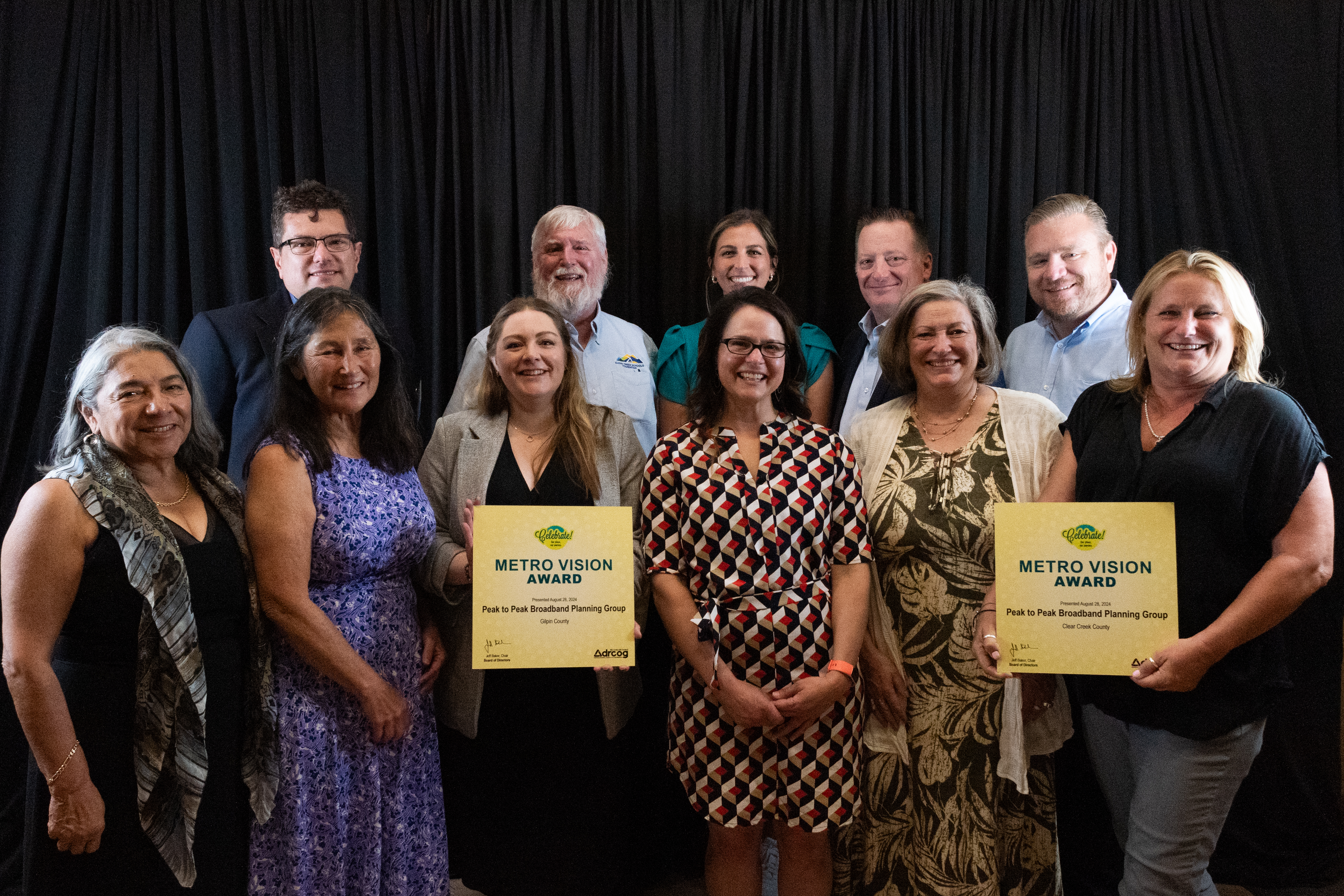 Gilpin County, Clear Creek County, and Town of Nederland elected officials and staff display the Metro Vision Award received by their Peak to Peak Broadband Planning Group.