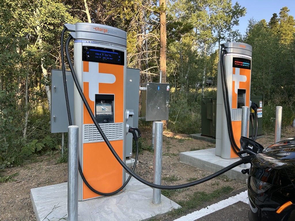2 level 3 chargers, one of which is charging a vehicle